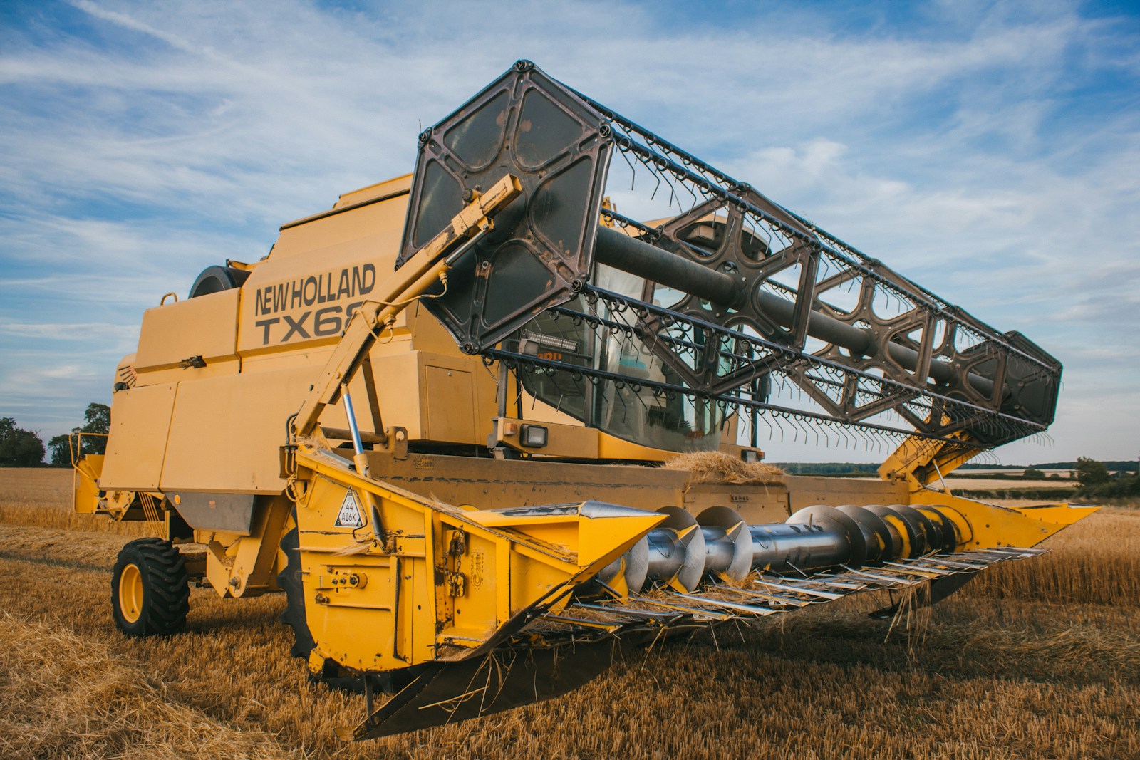 a big yellow machine in the middle of a field